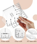 Close-up of person holding T-shirt ruler from All In One Heat Press Kit With 6 PTFE Sheets 12 By 16 Inches 8 T Shirt Alignment Rulers 3 Heat Resistant Tapes