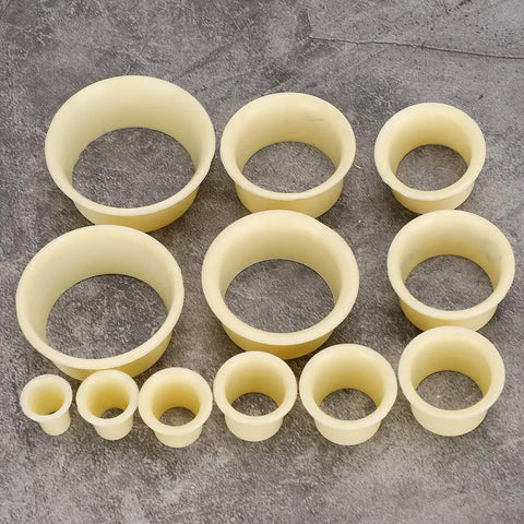 12 Piece Watch Movement Support Set With 12 Assorted Movement Holders for DIY watch repair, durable ABS crafted clamps displayed.