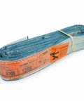 Heavy Duty 2 X 4 Foot Eye And Eye Polyester Rigging Sling Rated 6400 Lbs laid flat with orange label showing capacity details.