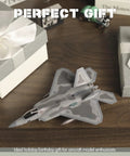 One Hundredth Scale F 22 Raptor Fighter Jet Model Dope Diecast Aircraft for Collectors on wooden table with gift boxes