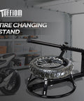 Heavy Duty Rugged Tire Change Stand For 16 To 21 Inch Tires Motorcycle Bead Popper in a garage setting