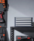 Five Drawer Drill Bit Dispenser Cabinet With Sixty Compartments For Jobber Length Bits 1 To 60 Clear Labeled Organizer For Quick Access And Neat Workshop Black Drill Bit Storage Cabinet on a shelf in a workshop setting.