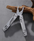 All In One Multitool Pliers With Replaceable Wire Cutters And Spring Loaded Action on a wooden background