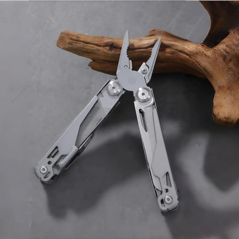All In One Multitool Pliers With Replaceable Wire Cutters And Spring Loaded Action on a wooden background