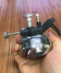 Hand holding Mini Butane Burner Portable Gas Stove With Aluminum Rack For Outdoor Camping And Home Science Experiments, 1300 C Heating, No Hoses Needed, Durable And Travel Ready, Ideal For Coffee Heating And Quick Lab Tasks.