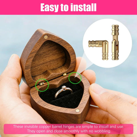 Hand holding a wooden ring box with 25 Piece Brass Hidden Cylinder Hinges Kit installed, showcasing ease of use and precision.