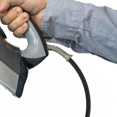 Person holding an iron with the Heavy Duty High Temperature Steam Hose for Steam Irons and High Pressure Ironing attached