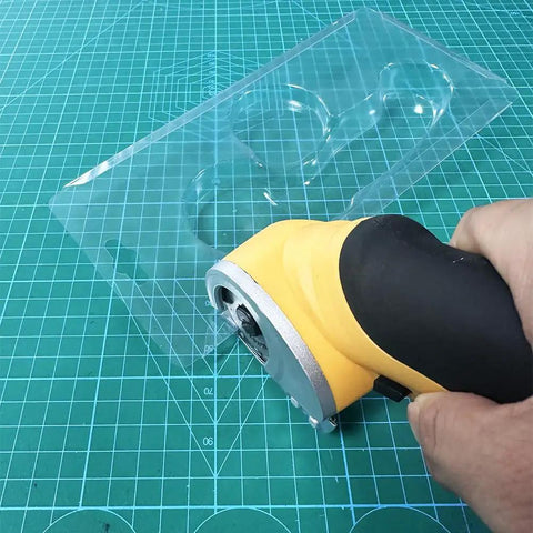 Heavy Duty Replacement Blades For Worx ZipSnip Electric Scissors cutting through clear plastic sheet on green grid cutting mat.
