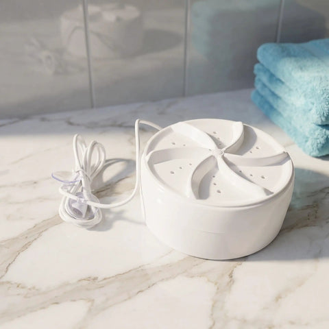 Chill Road Trip Ready Mini Turbo Washer Built For Real Deal RV Campers And Frequent Travelers on a marble countertop with towels.