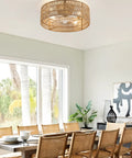 Retro BoHo Flush Mount Ceiling Fan With Open Caged Design And Integrated Warm Led Lighting, hanging over a dining table.