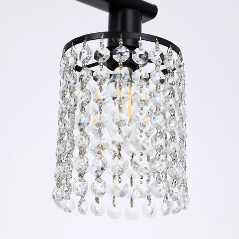 Close-up of gold crystal 3 light vanity light over mirror, featuring modern bathroom fixture with elegant crystal strings
