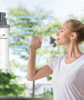 Woman drinking from Lightweight Running Hydration Vest With Two 250ml TPU Soft Flasks, BPA Free Bottle System outdoors.