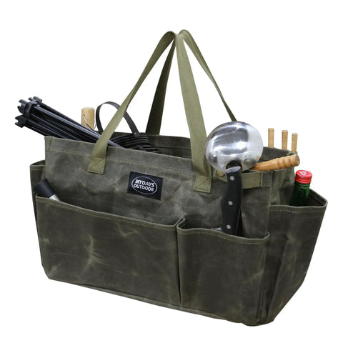 Army green waxed canvas firewood carrier tote filled with garden tools and utensils, showing collapsible and sturdy design.
