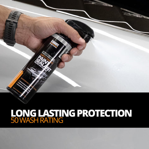 Hand holding Platinum Rapid Ceramic Paint Sealant Spray 14 Oz With 50 Wash Rating For Boss Gloss And Shine over car surface.