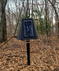 Heavy Duty Solar Hanging Enclosure For LoRa Nodes, mounted in the woods, featuring a solar panel and secure fit for batteries.