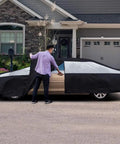 Man using Heavy Duty Waterproof Sedan Car Cover 186 To 202 Inches With Driver Side Zipper UV Protection in driveway.