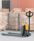 Compact Electric Pallet Jack Truck With Lithium Battery, 48 Inch Forks, 4400 Lb Capacity, in front of stacked boxes.