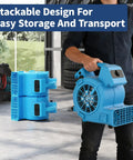 Man carrying a Powerful Air Mover 1/8 HP 550 CFM Carpet Dryer and Floor Blower with stackable design for transport.