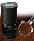 Automatic Coffee Tamper With 58Mm Portafilter and digital display beside ground coffee in portafilter for smooth espresso pulls.