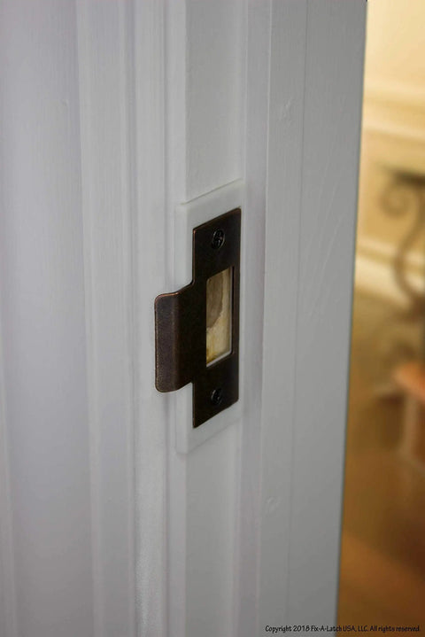 Close-up of Quick Door Latch Repair Kit With Bronze Finish installed on a door frame, showcasing its easy application and fit.
