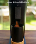 Solid Single Dose Coffee Grinder Featuring 63Mm Red Titanium Conical Burrs And Plasma Ionizer dispensing ground coffee.