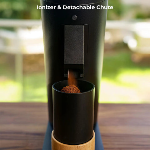 Solid Single Dose Coffee Grinder Featuring 63Mm Red Titanium Conical Burrs And Plasma Ionizer dispensing ground coffee.