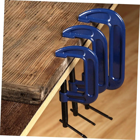 Beefy Heavy Duty 4 Inch Woodworking G Clamp C Clamp with tabletop mounting in blue, securing wood panel for precise workholding.