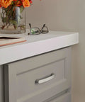 Contemporary Satin Nickel Cabinet Pull Rift Finish With Four And A Quarter Inch Overall Length And Three And Three Quarters Inch Center To Center Mounting Holes Ideal For Cabinets Drawers And Furniture Modern Drawer Handle installed on a gray cabinet with orange flowers.