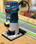 Guide Rail Adapter Compatible With Bosch Colt 1Hp Router For Track Saw Systems, mounted on a workbench with a guide rail.