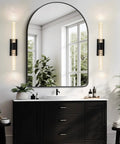 Crystal Battery Operated Wall Sconce Set of 2,Rechargeable Wall Sconces with Remote Control,Modern Black Bathroom Vanity Light fixtures,Wireless Dimmable Wall Lights for Bedroom Living Room Hallway installed beside a round mirror.