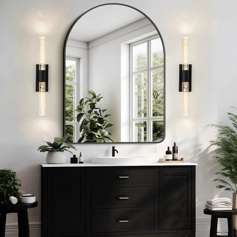 Crystal Battery Operated Wall Sconce Set of 2,Rechargeable Wall Sconces with Remote Control,Modern Black Bathroom Vanity Light fixtures,Wireless Dimmable Wall Lights for Bedroom Living Room Hallway installed beside a round mirror.