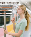 Person on train using Portable Mini Handheld Fan With USB Rechargeable Power Bank And Built In LED Flashlight Foldable Pocket Cooling Fan