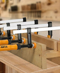 Four 6 Inch F Clamp Set For Woodworking, 300 Lbs Clamping Force, Ergonomic Grip Bar Clamps in workshop setting