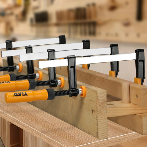 Four 6 Inch F Clamp Set For Woodworking, 300 Lbs Clamping Force, Ergonomic Grip Bar Clamps in workshop setting