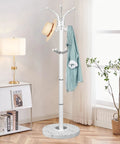 Sleek Freestanding Coat Rack With 360 Degree Swivel Hooks And Marble Base, 14 Hooks For Bags, Hats, And Coats in modern room.
