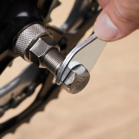 Person using Crank Puller Tool For Mountain And Road Bikes With Square Taper Bottom Bracket Splined ISIS Drive And Octalink Compatibility Pro Grade Heavy Duty Classic Model For Easy Crank Arm Removal
