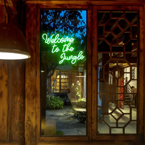 Welcome To The Jungle Neon Sign Green LED Light For Wall Decor USB Powered Jungle Theme Decor indoors on wall near window