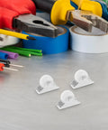 Four Piece Fixed Caster Wheels For Furniture And Cabinets, Durable Non Swivel Polypropylene Rollers on a work surface with tools.