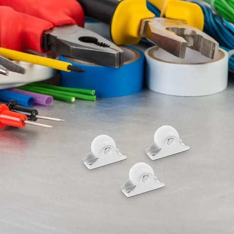 Four Piece Fixed Caster Wheels For Furniture And Cabinets, Durable Non Swivel Polypropylene Rollers on a work surface with tools.