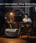 Man working at desk with Delta 3 Ultra Portable Power Station With Solar Panel And 3072Wh LiFePO4 Battery nearby powering devices.