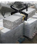 Premium Granite Slab Lifting Clamp With Adjustable Chain Stone Carrier lifting a granite block between stacked slabs at a construction site.