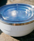 Rambler Bowl Vacuum Insulated Stainless Steel With Lid 1 Quart Navy, close-up of lid and stainless steel edge on a sunny day.