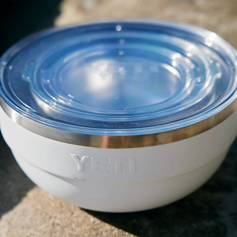 Rambler Bowl Vacuum Insulated Stainless Steel With Lid 1 Quart Navy, close-up of lid and stainless steel edge on a sunny day.