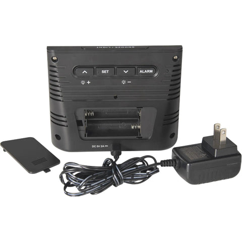 Back view of Weather Forecaster Alarm Clock With Wireless Qi Charging Pad showing battery compartment and power adapter.