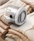 Mini Portable Washing Machine for Socks and Undies 1.6L Cordless USB Rechargeable Battery Operated Compact Laundry Washer beside folded clothes.