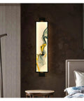 Game Changer Led Wall Sconce With Chill Cool White Glow, super dope vertical lamp illuminating a stylish bedroom wall.