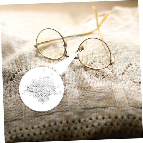 200-Piece Eyewear Repair Kit With Metal Spacers And Washers For Quick Eyeglass Frame Repairs with round glasses on fabric.
