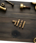 Solid Brass Pro Grade Hidden Hinges Set For Keepsake Boxes And Wooden Cabinets displayed on wooden surface