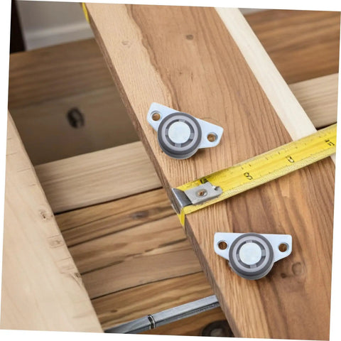 Set Of Four Adjustable Door Wheel Rollers For Sliding Closet Barn Doors With Heavy Duty Silent Pulleys Quick No Sweat Side Or Vertical Mount Hardware For Movable Furniture And Cabinets attached to wood with a measuring tape.