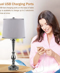 Woman charging phone with Industrial USB Table Lamp Set Of 2 With Dope Dual USB Charging Ports, Gray Bedside Lamps, 25.9" tall